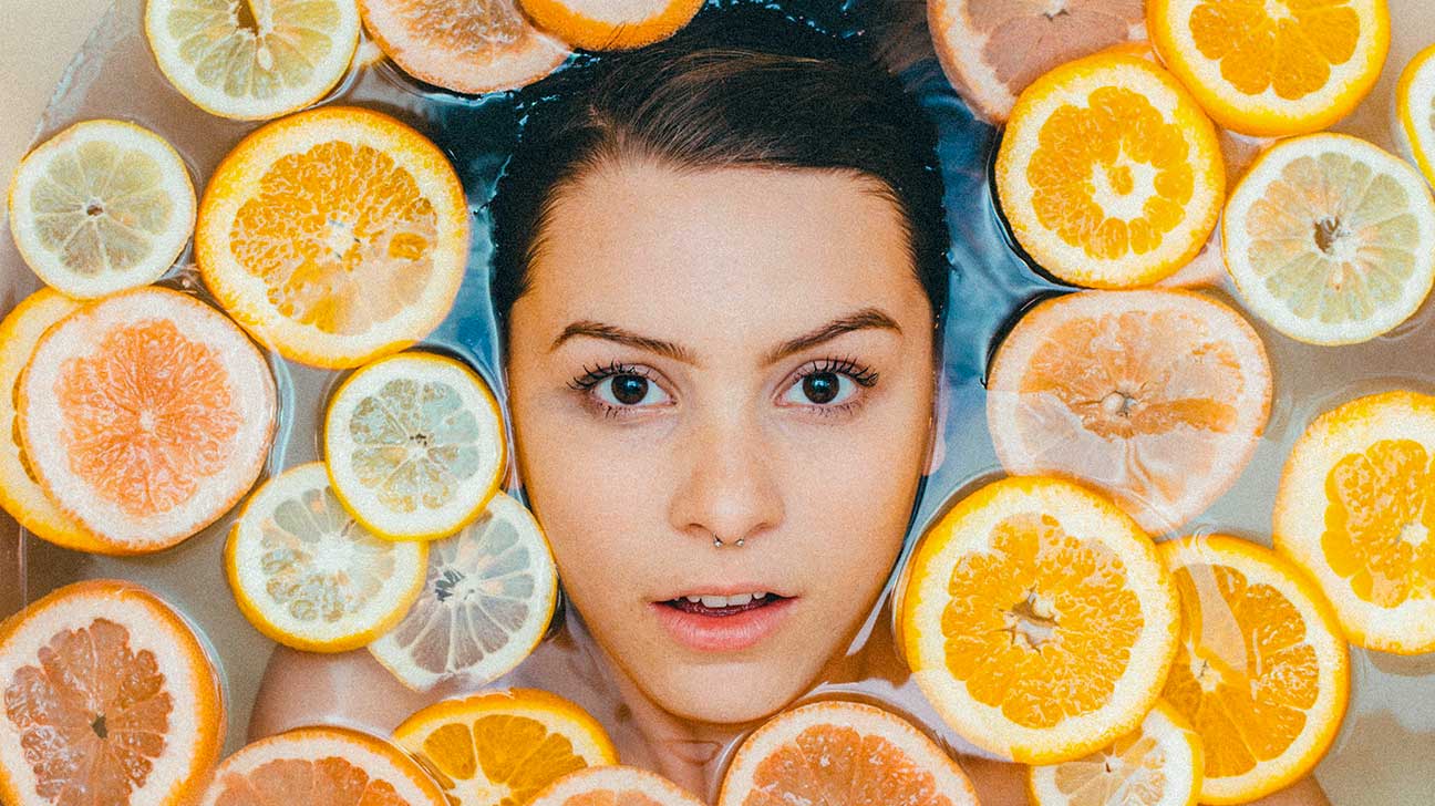 Woman bath face oranges 1296x728 header